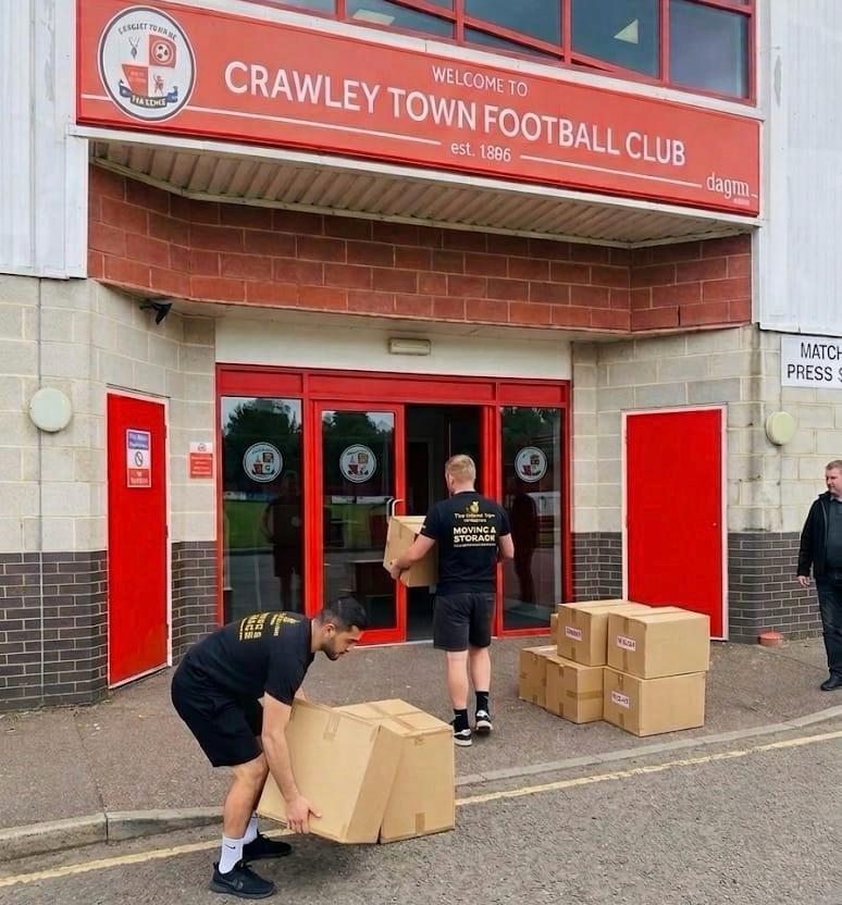 Yellow Van Company branded removal van at Crawley Town FC delivering kit for an event &mdash; reliable event and removals logistics across RH10, RH11 and West Sussex since 2011