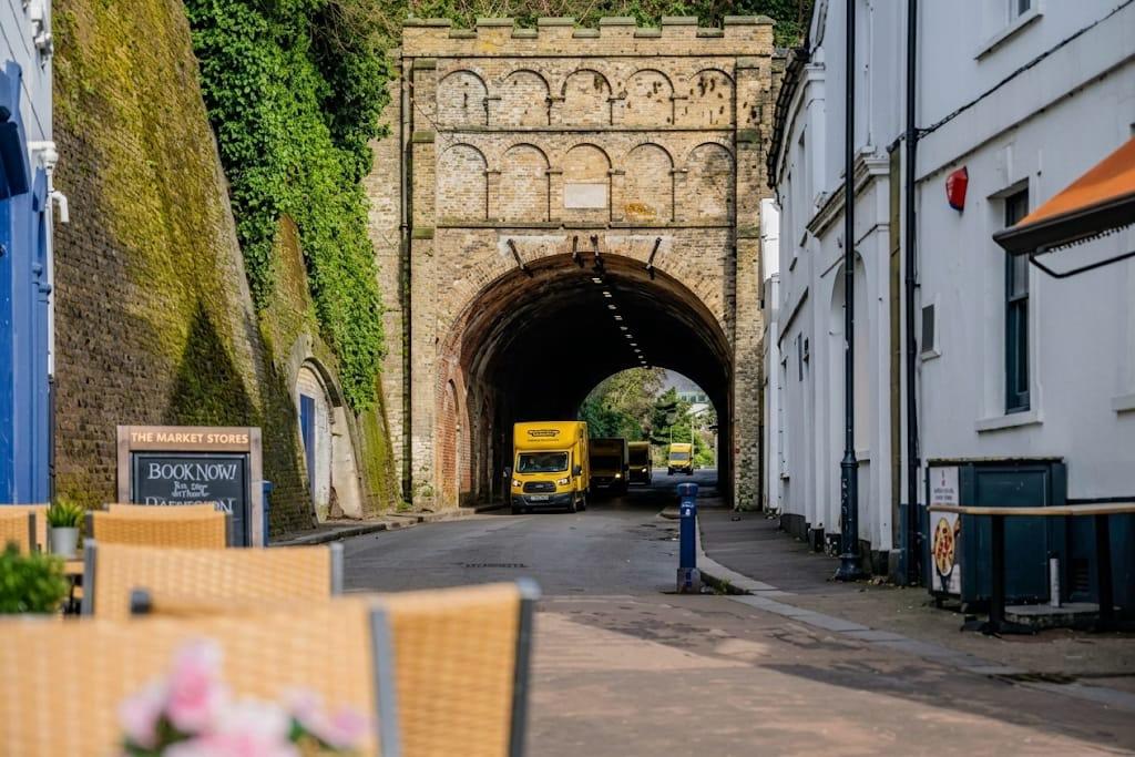 Yellow Van Company branded van by the historic Reigate Tunnel &mdash; trusted family-run removals across RH2 and Surrey since 2011
